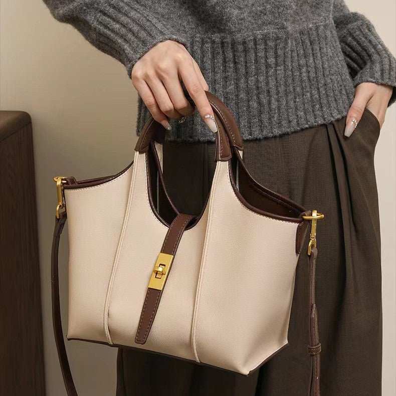 Chic high-end crossbody bag with adjustable strap, shown angled to highlight hardware and zipper closure
