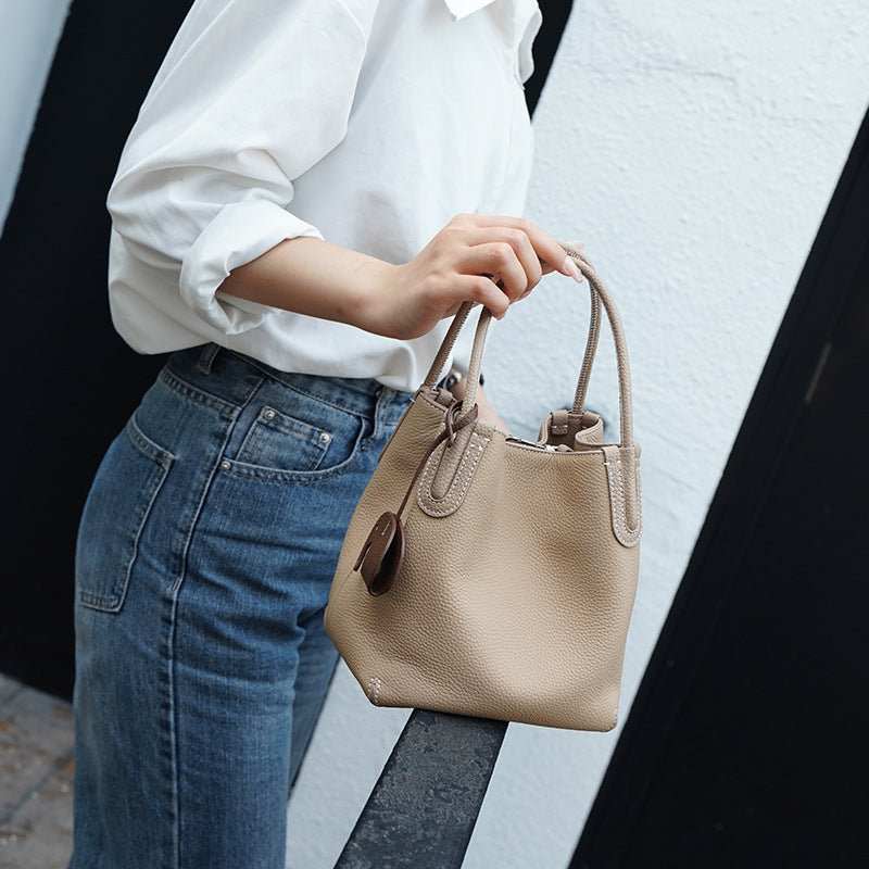 Genuine leather crossbody bag with adjustable strap and top handle, side profile
