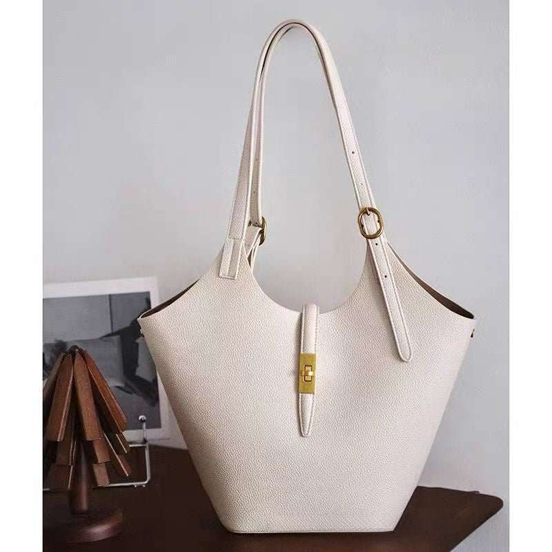 Women’s tote bag with adjustable drop handles carried over shoulder height