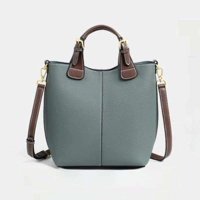 Gray genuine leather crossbody bag for women with brown handles and gold hardware in a structured bucket design