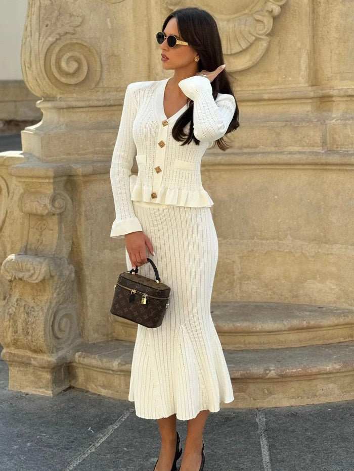 Elegantly tailored knit cardigan and skirt set in soft fabric, laid flat to show set details