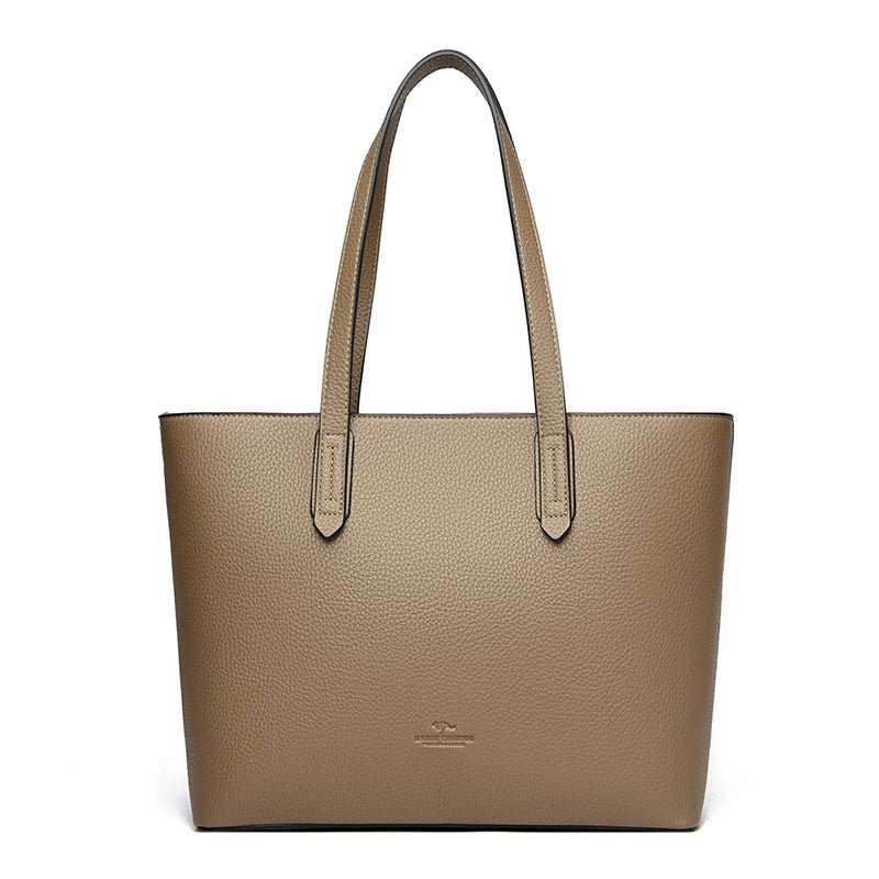PU leather travel tote, internal padded laptop sleeve, shown with everyday essentials inside