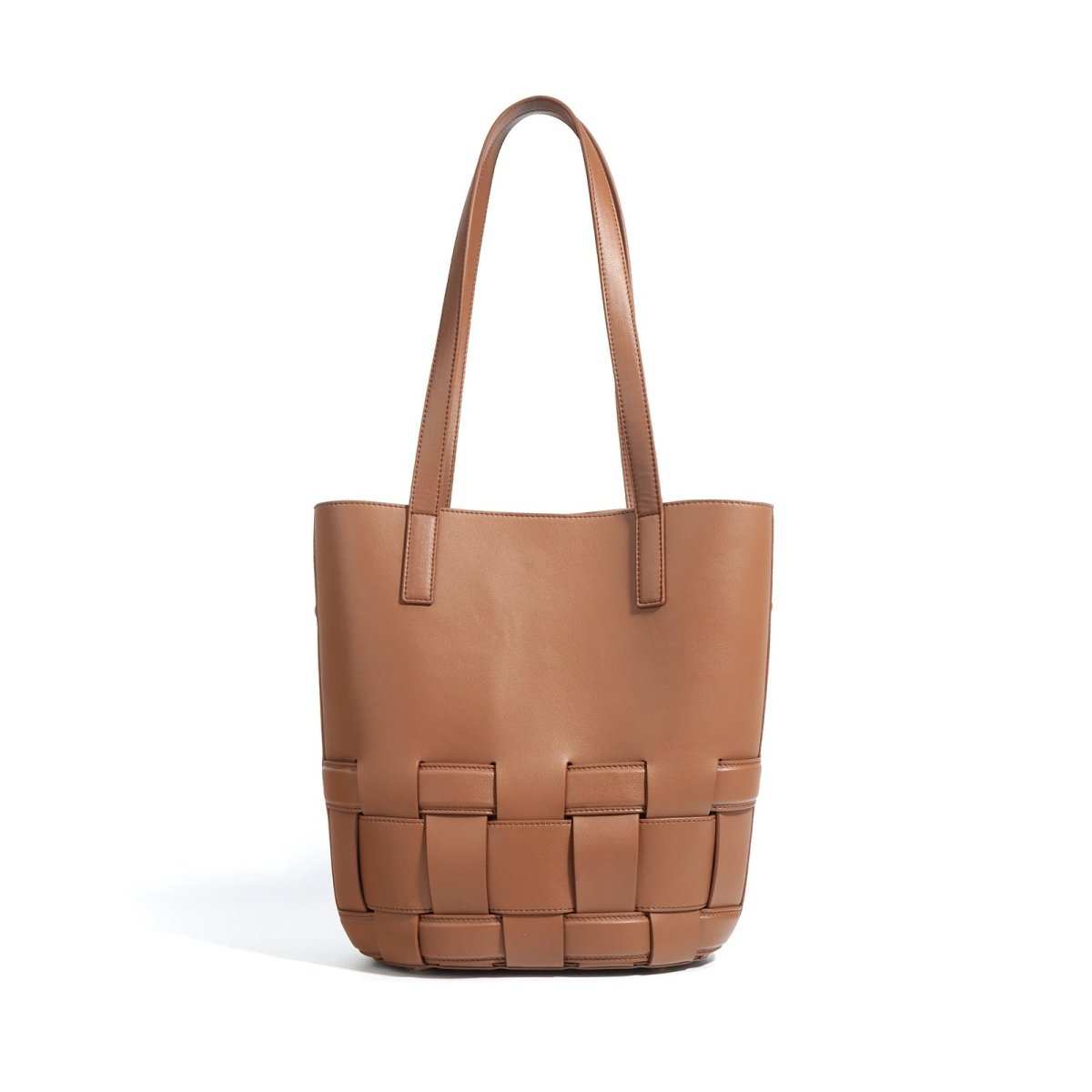 Women’s woven cowhide tote with structured handles highlighted against a neutral background