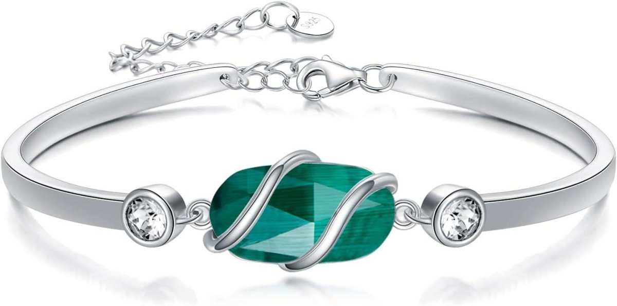 Adjustable green malachite bangle worn on wrist, showcasing fit and stone banding pattern