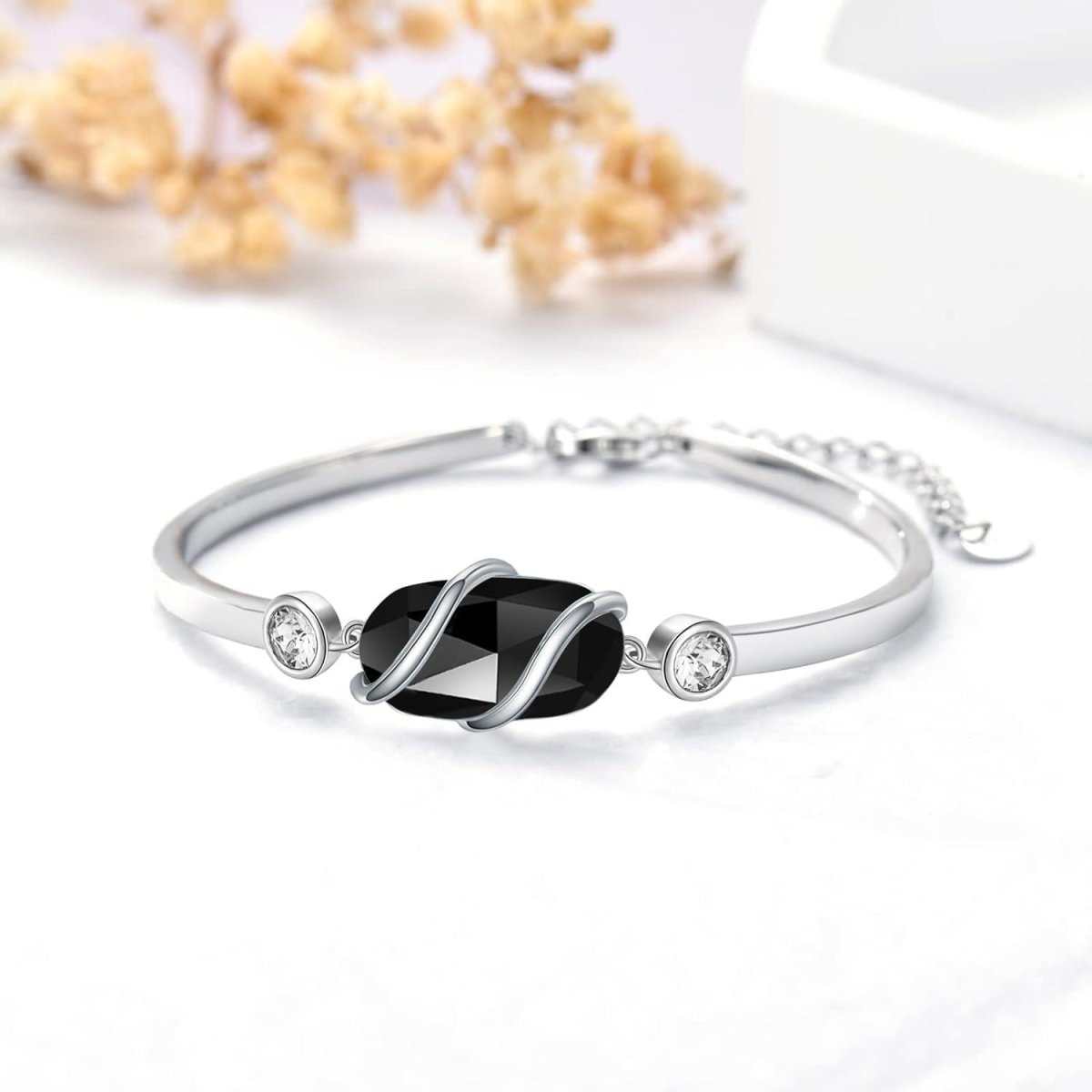 Green malachite and 925 sterling silver adjustable bangle, front view on white background