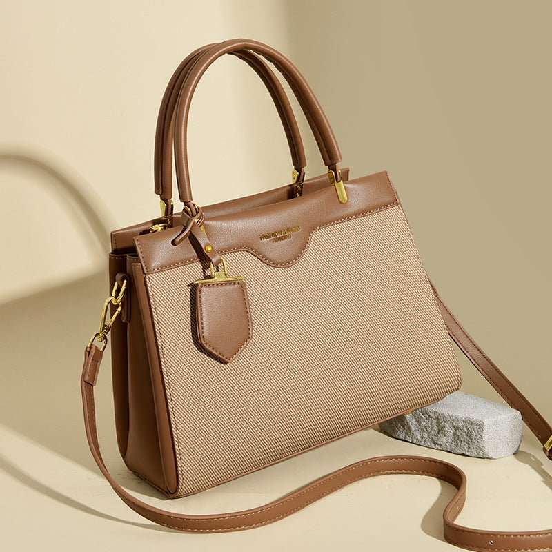 Light luxury messenger bag, side profile highlighting structured base and contrast stitching