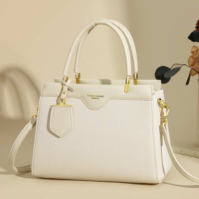 Messenger bag with adjustable shoulder strap, detailed view of soft PU exterior