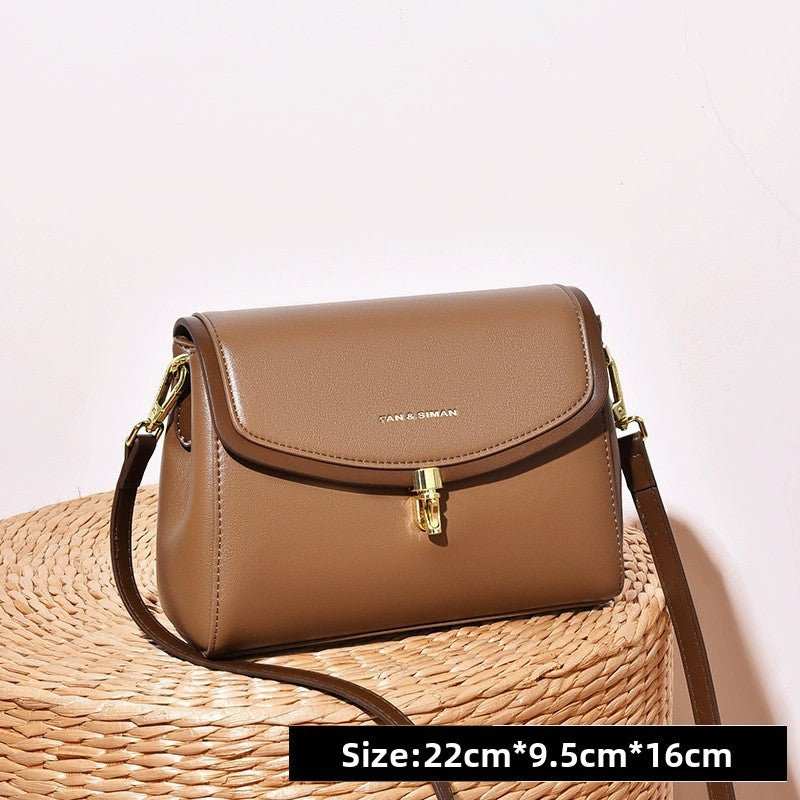 Minimalist soft leather XL shoulder bag with wide adjustable strap in black, displayed on white background