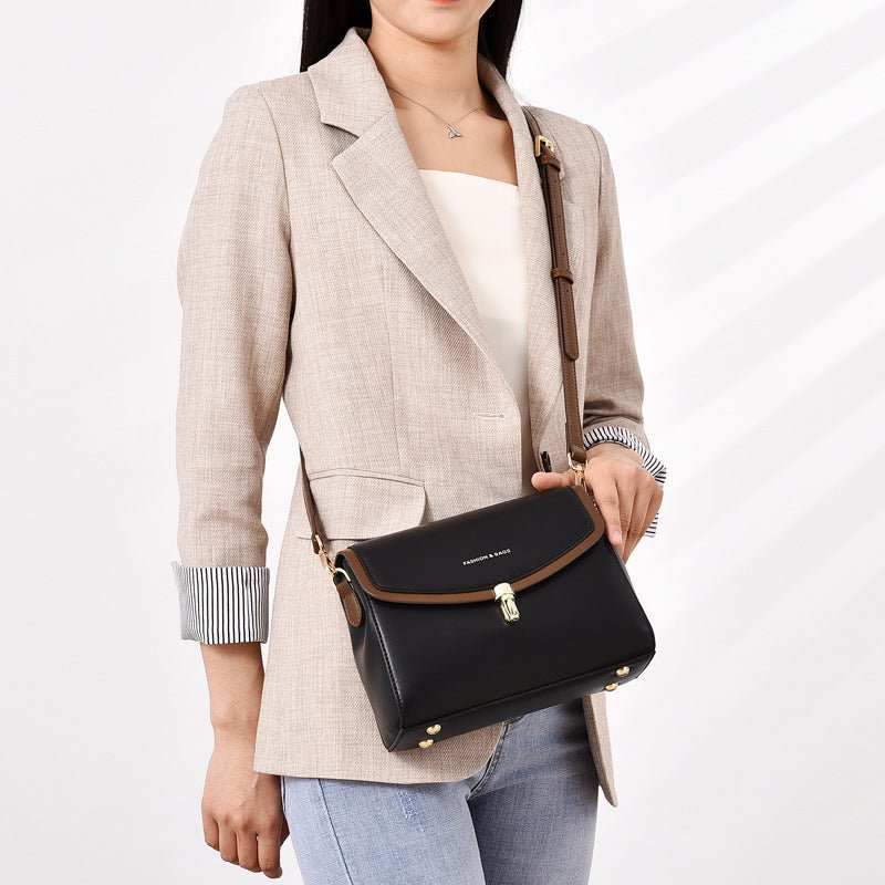 Soft leather shoulder bag interior showing organized compartments and polyester lining