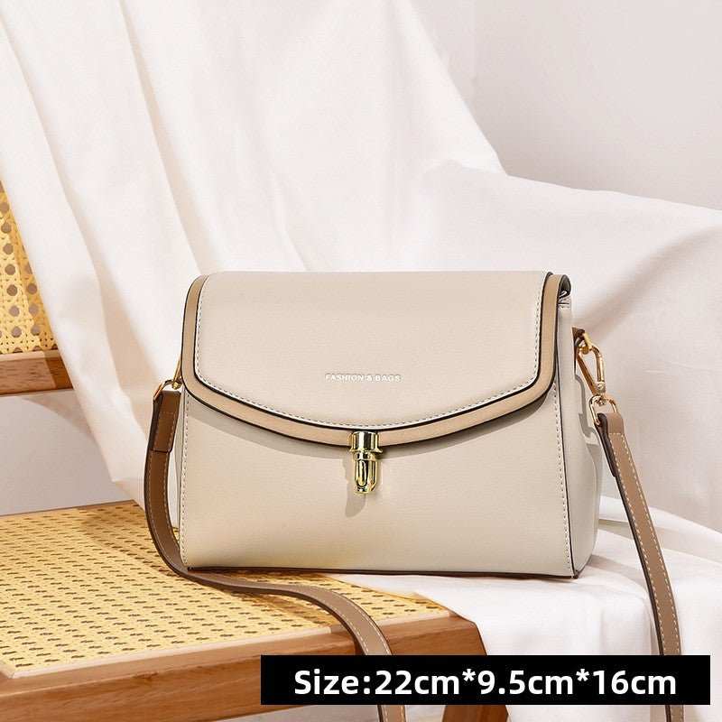 Minimalist soft leather shoulder bag showing top zipper secure closure and subtle contrast trim