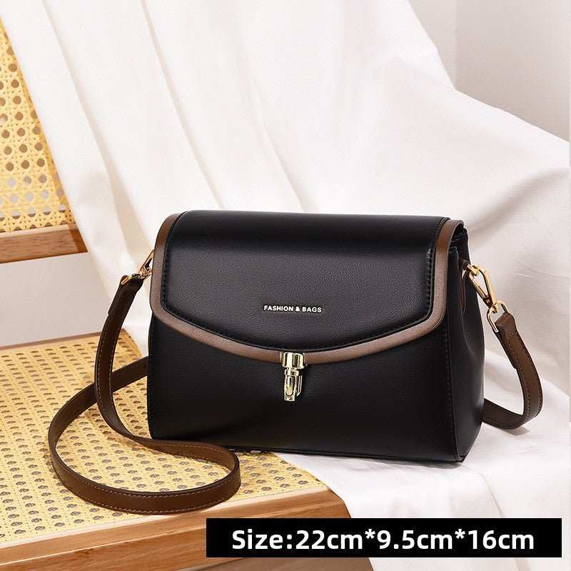 Women’s XL minimalist soft leather purse on table, showing versatile horizontal square silhouette