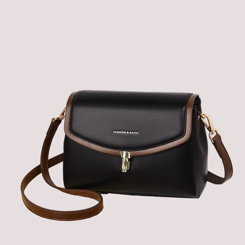 Minimalist soft leather women’s shoulder bag with secure zip closure, shown angled to highlight depth