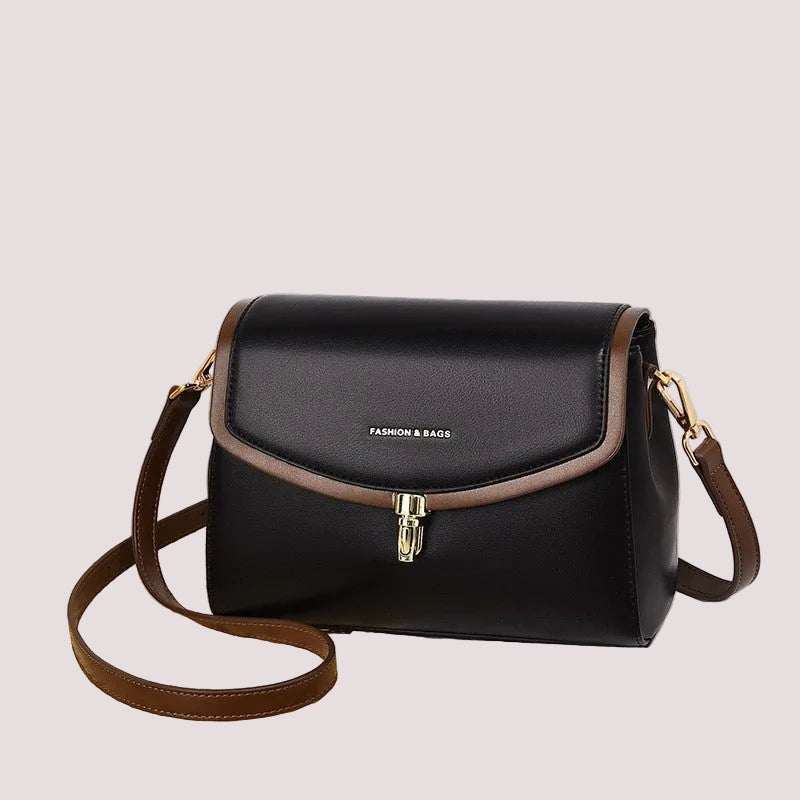Minimalist soft leather women’s shoulder bag with secure zip closure, shown angled to highlight depth