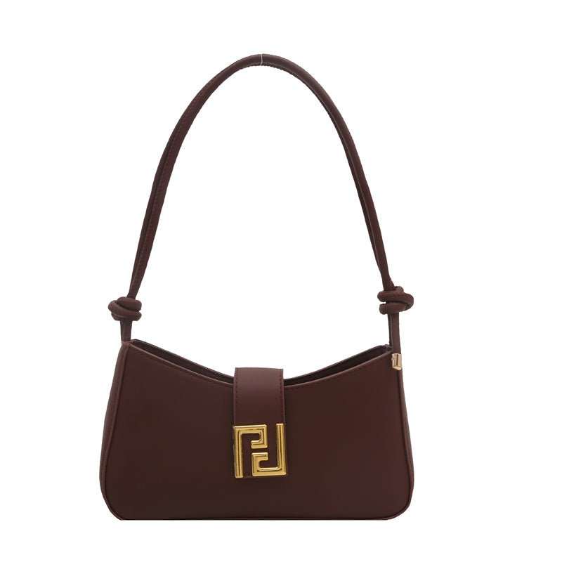 Black structured women’s purse with gold-tone hardware, side view highlighting bag’s shape retention
