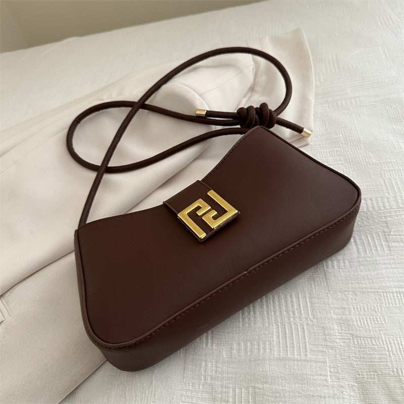 Women’s classic structured handbag in synthetic leather with visible polyester lining and interior pocket