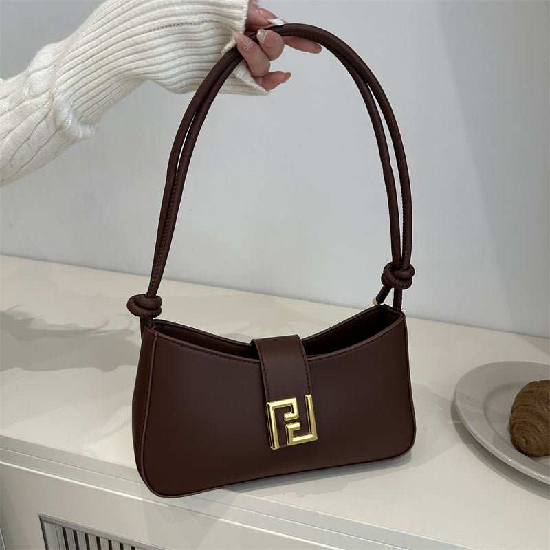 Sleek women’s structured everyday handbag showing top zipper and comfortable shoulder strap