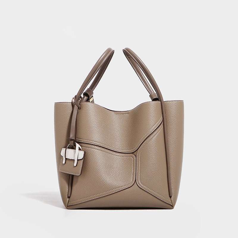 Urban Chic leather tote handbag for women in black, shown with adjustable straps and structured silhouette