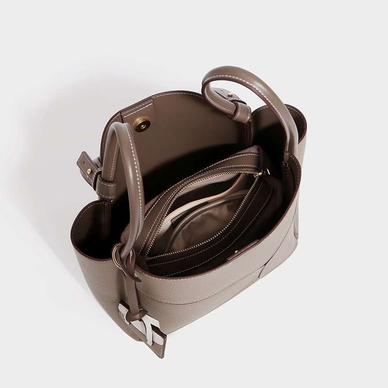 Detailed view of Urban Chic leather tote, highlighting reinforced stitching and adjustable leather handles