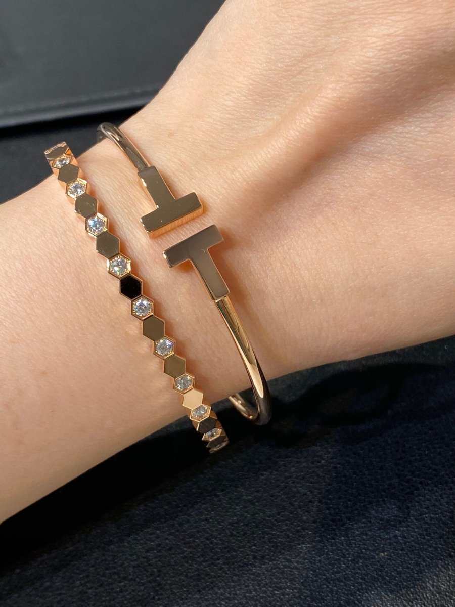 Sterling Silver Honeycomb Bracelet in gold with hexagonal link design paired with a sleek gold cuff bracelet on wrist