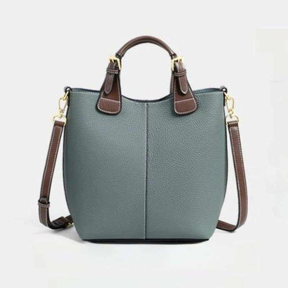 Gray genuine leather crossbody bag for women with brown handles and gold hardware in a structured bucket design