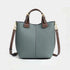 Gray genuine leather crossbody bag for women with brown handles and gold hardware in a structured bucket design
