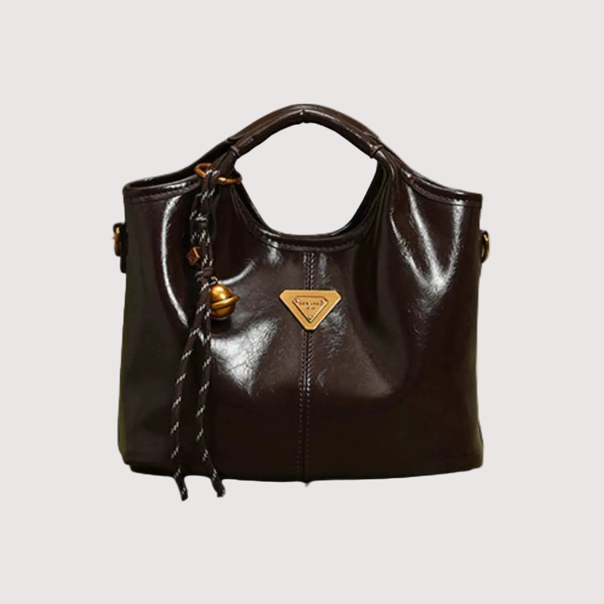 Elegant PU Leather Women’s Tote in dark brown with smooth texture, stitched detailing, soft handles, and a braided pendant