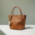 Genuine leather crossbody handbag with sleek bucket silhouette in black