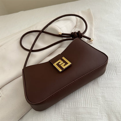 Women’s classic structured handbag in synthetic leather with visible polyester lining and interior pocket