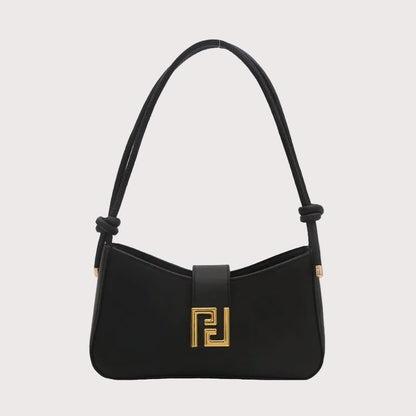 Structured women’s handbag in black PU leather with shoulder strap, elegant shape, and gold hardware