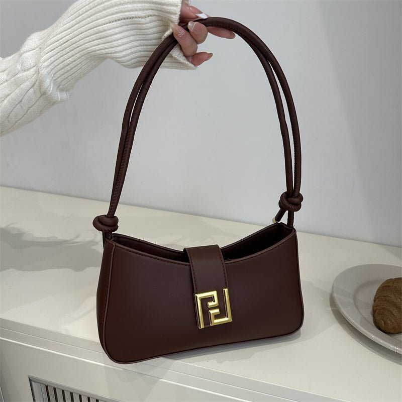 Sleek women’s structured everyday handbag showing top zipper and comfortable shoulder strap