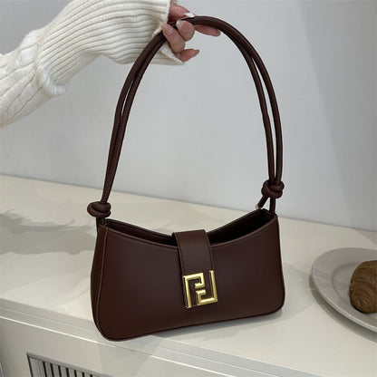 Sleek women’s structured everyday handbag showing top zipper and comfortable shoulder strap