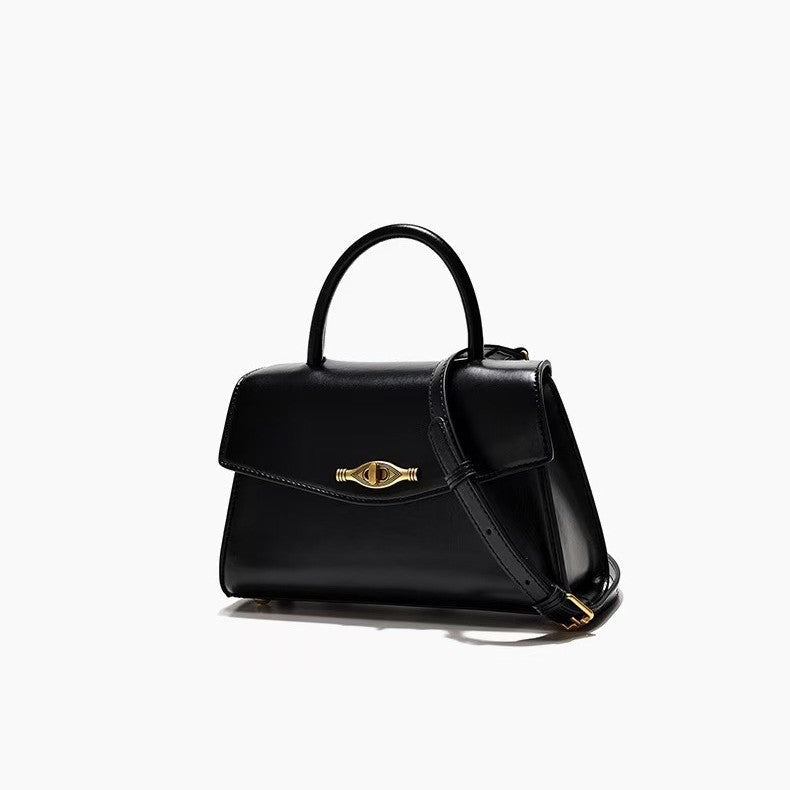 Vintage Metal Buckle black synthetic leather handbag with structured shape, top handle, flap closure, and shoulder strap