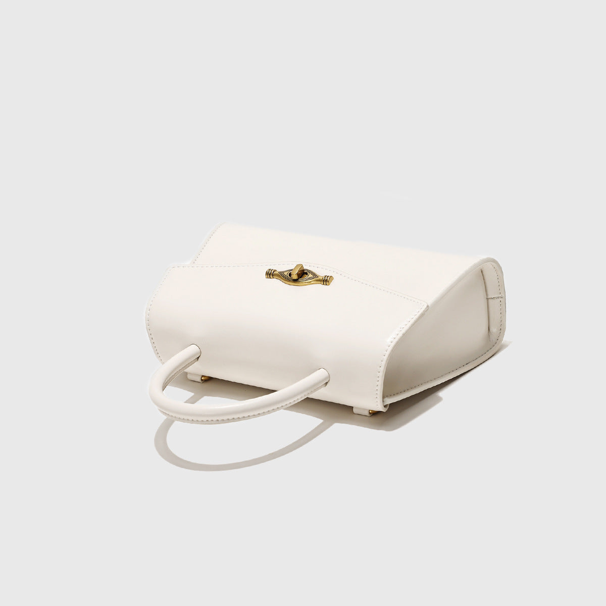 Vintage Metal Buckle handbag in cream white synthetic leather with a structured shape and top handles